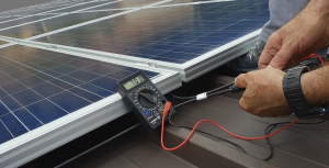 A Solar Energy Technician installs panels on a rooftop.